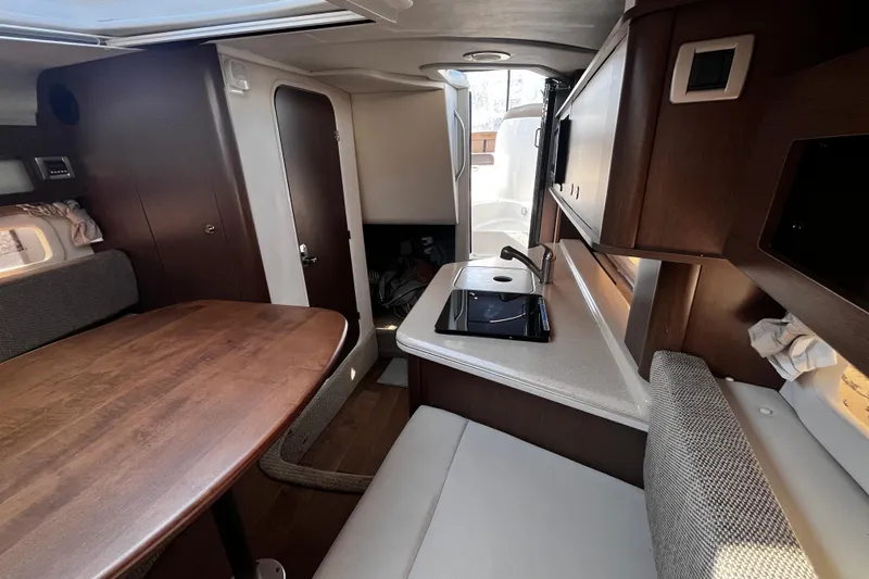 Slide: The Image of Interior of 2016 Sea Ray 280 Sundancer with kitchenette and dining area. - 22