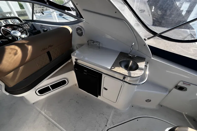 Slide: The Image of Interior of 2016 Sea Ray 280 Sundancer with helm, sink, and seating area. - 8