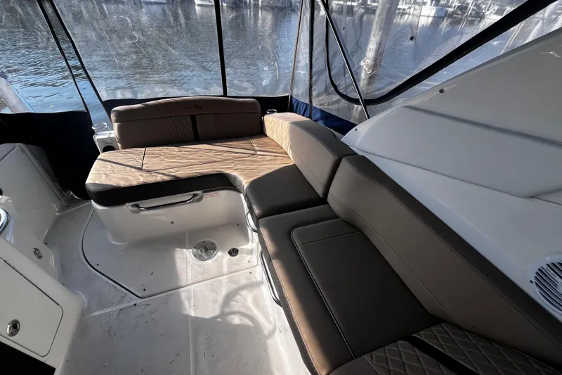 Slide: The Image of 2016 Sea Ray 280 Sundancer interior with cushioned seating and water view. - 9