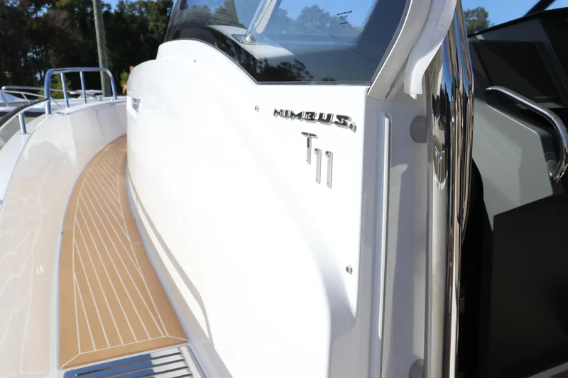 Slide: The Image of 2025 Nimbus T11 boat with sleek white design and wood-textured deck. - 27
