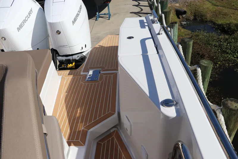 Slide: The Image of Nimbus T11 2025 boat deck with Mercury engines and sleek wood finish. - 28