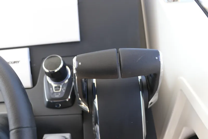 Slide: The Image of Control panel of 2025 Nimbus T11 boat with throttle levers and joystick. - 38