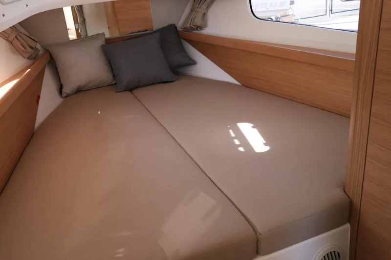 Slide: The Image of Cozy interior cabin of 2025 Nimbus T11 with beige bedding and cushions. - 48