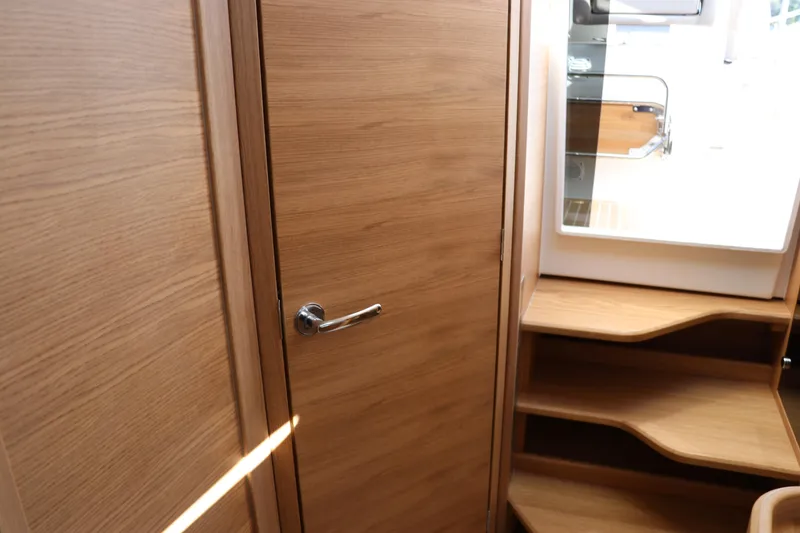 Slide: The Image of Interior of 2025 Nimbus T11 boat with wooden door and steps. - 49