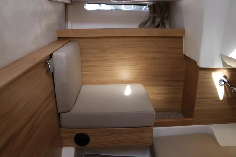 Slide: The Image of Modern interior of 2025 Nimbus T11 boat with wooden paneling and cushioned seating. - 52
