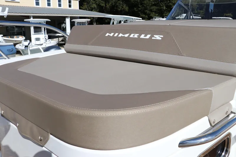 Slide: The Image of Nimbus T11 2025 boat with beige cushioned seating, showcasing luxury and comfort. - 61