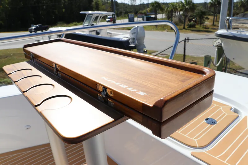 Slide: The Image of Wooden table on Nimbus T11 boat, 2025 model, featuring cup holders and sleek design. - 62