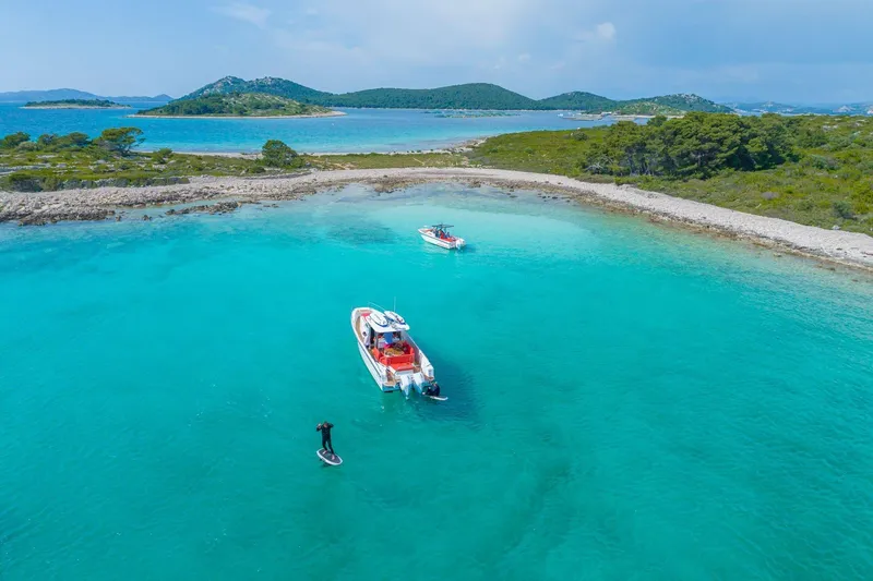 Slide: The Image of Aerial view of Nimbus T11 boat in turquoise waters near a scenic island, 2025 model. - 68