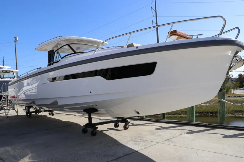 Slide: The Image of 2025 Nimbus T11 boat on trailer, displayed outdoors under clear blue sky. - 7