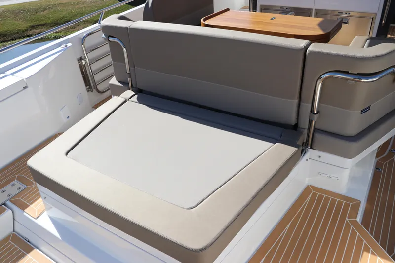 Slide: The Image of Group enjoying a meal on a 2025 Nimbus T11 yacht, surrounded by blue ocean. - 14