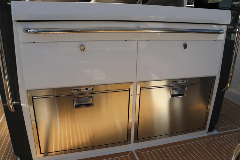 Slide: The Image of Open storage compartment in 2025 Nimbus T11 boat, showcasing interior equipment and components. - 20