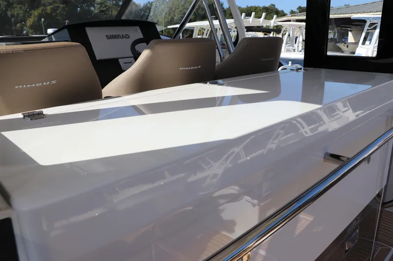 Slide: The Image of Nimbus T11 2025 boat deck with Mercury engines and sleek wood finish. - 22