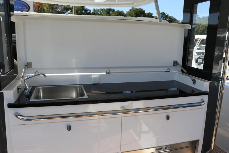 Slide: The Image of Luxury seating in 2025 Nimbus T11 boat cockpit, featuring beige upholstery and modern design. - 24