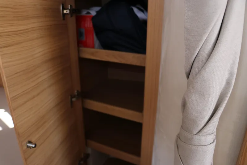 Slide: The Image of Interior of 2025 Nimbus T11 boat with wooden door and steps. - 43