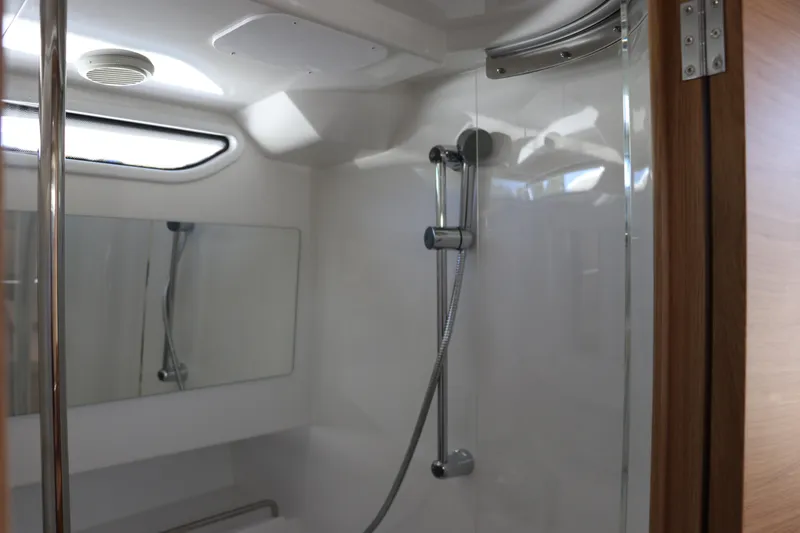 Slide: The Image of Deck of Nimbus T11 2025 boat with cleat and control dials. - 57