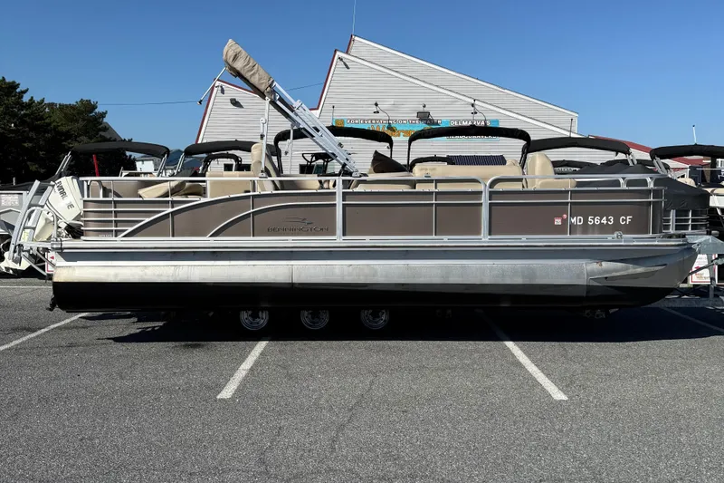 The Image of 2013 Bennington 2275 GFS pontoon boat parked in a marina lot. - 1
