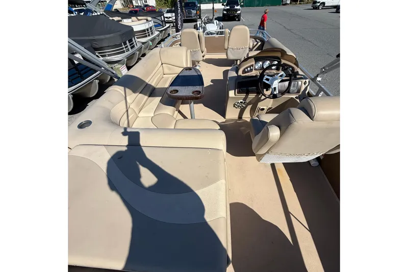 Slide: The Image of 2013 Bennington 2275 GFS pontoon boat interior with beige seating and steering console. - 12