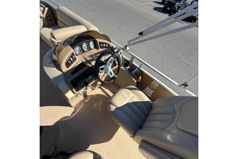 Slide: The Image of 2013 Bennington 2275 GFS boat interior with steering wheel and dashboard controls. - 16
