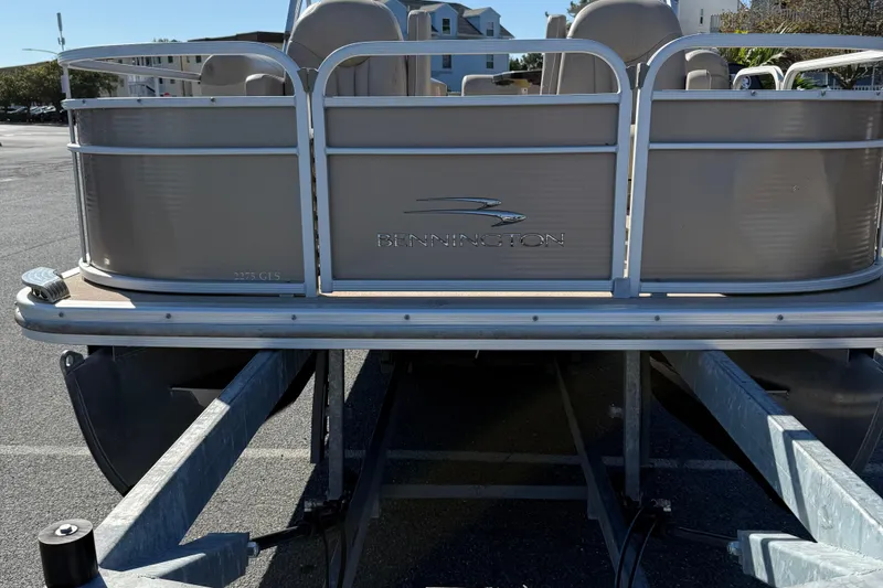 Slide: The Image of 2013 Bennington 2275 GFS pontoon boat on trailer in parking lot. - 3