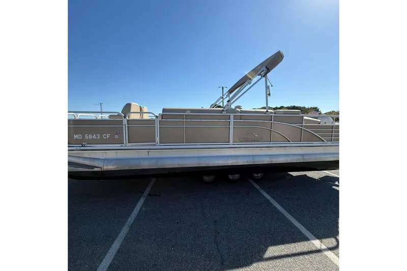 Slide: The Image of 2013 Bennington 2275 GFS pontoon boat parked in a lot under clear blue sky. - 5