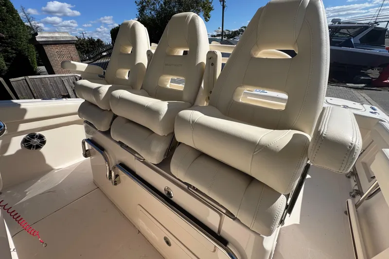 Slide: The Image of Luxury seating on 2022 Grady-White Canyon 326 boat, featuring plush, cream-colored upholstery. - 12