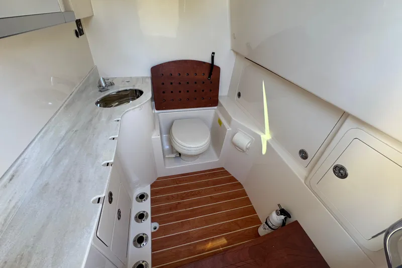 Slide: The Image of 2022 Grady-White Canyon 326 boat interior with toilet and sink. - 16