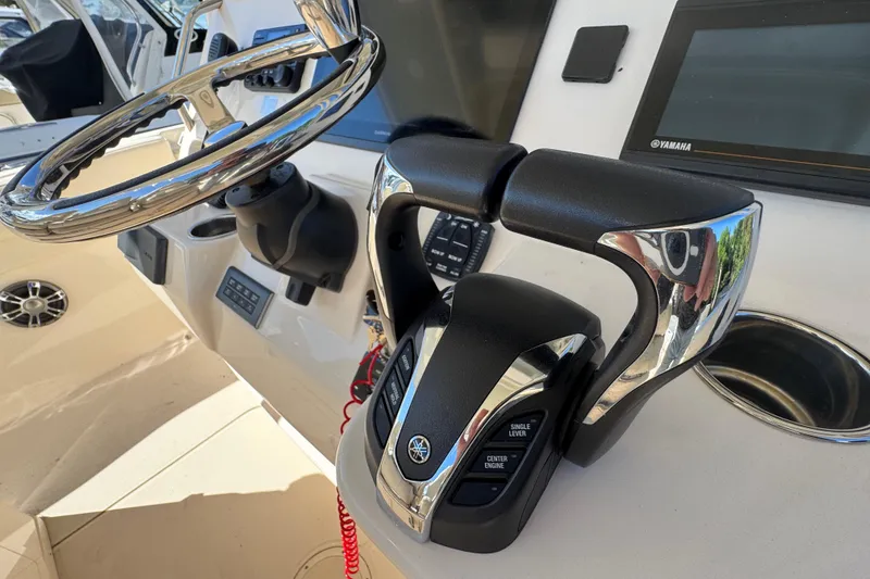 Slide: The Image of 2022 Grady-White Canyon 326 boat helm with steering wheel and controls. - 18
