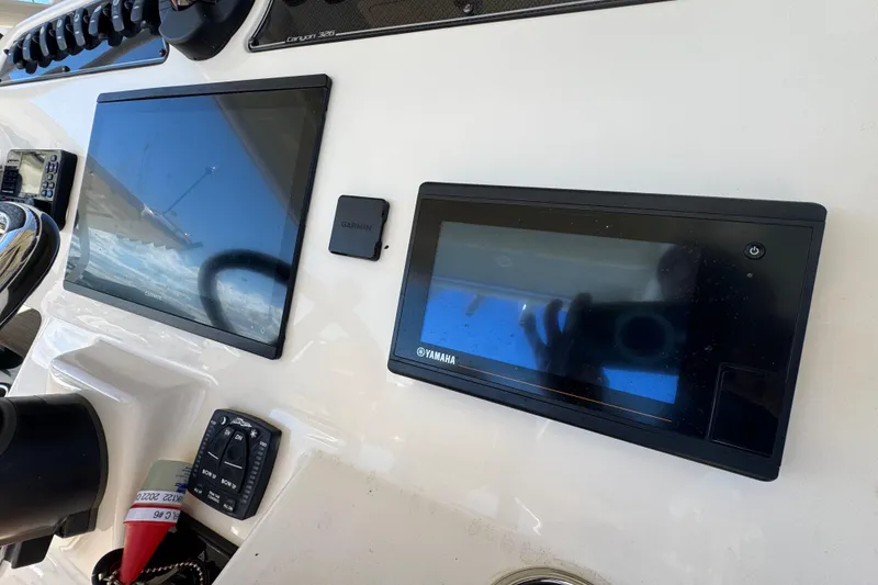 Slide: The Image of Control panel of 2022 Grady-White Canyon 326 boat with Garmin and Yamaha displays. - 19