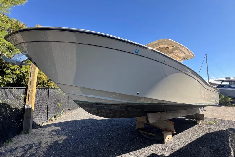 Slide: The Image of 2022 Grady-White Canyon 326 boat on display, viewed from below against a clear blue sky. - 2