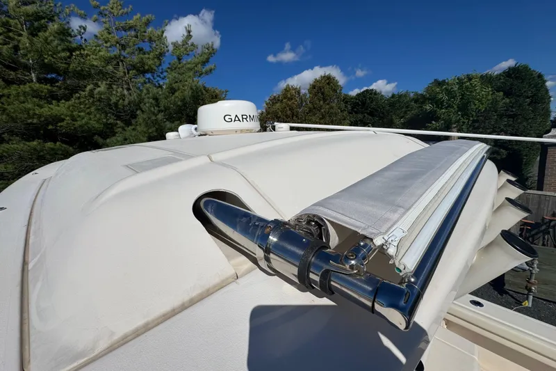 Slide: The Image of 2022 Grady-White Canyon 326 boat with Garmin radar, under clear blue sky. - 22