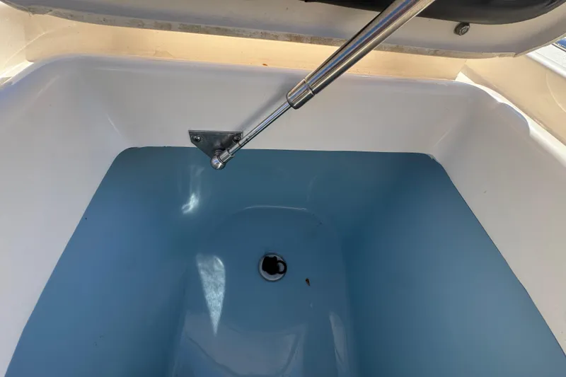 Slide: The Image of Livewell interior of 2022 Grady-White Canyon 326 boat, featuring hydraulic support. - 25