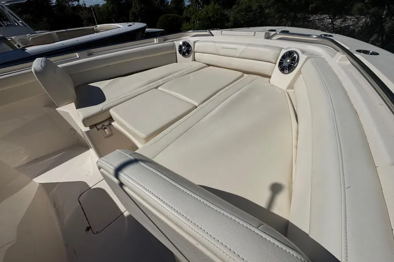 Slide: The Image of 2022 Grady-White Canyon 326 boat interior with cushioned seating and speakers. - 31