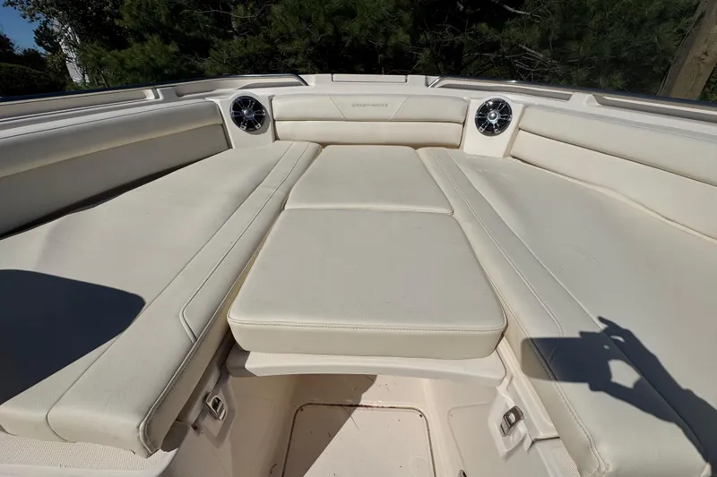 Slide: The Image of 2022 Grady-White Canyon 326 boat interior with cushioned seating and speakers. - 32