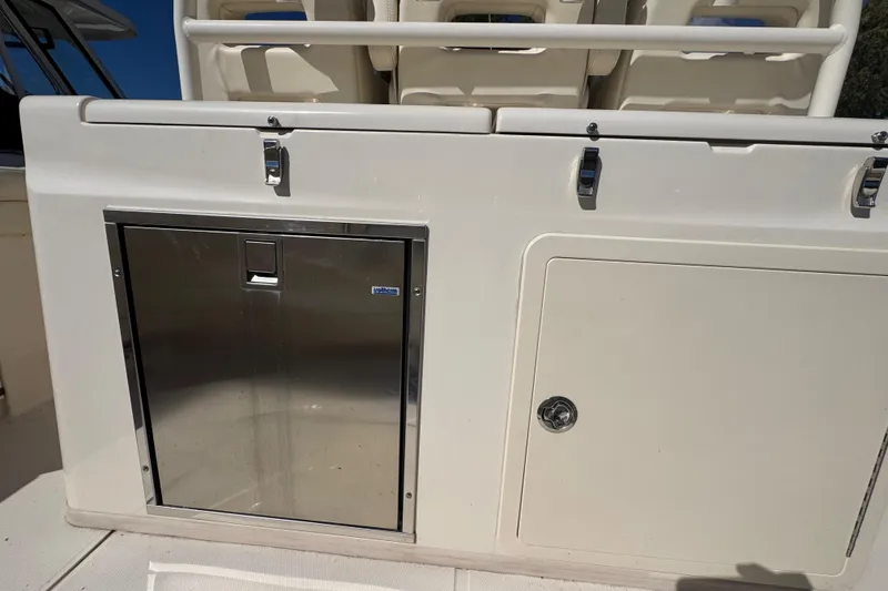 Slide: The Image of 2022 Grady-White Canyon 326 boat interior with storage compartments and stainless steel door. - 38