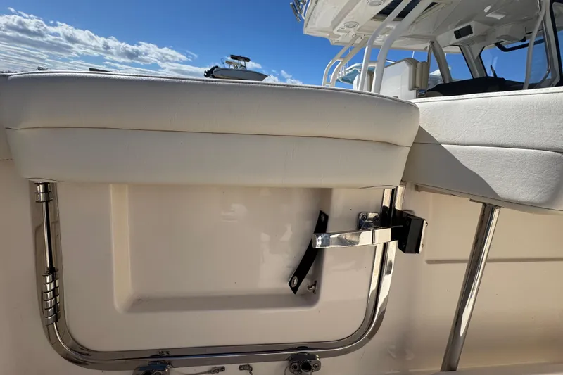 Slide: The Image of 2022 Grady-White Canyon 326 boat seating detail under a clear blue sky. - 39