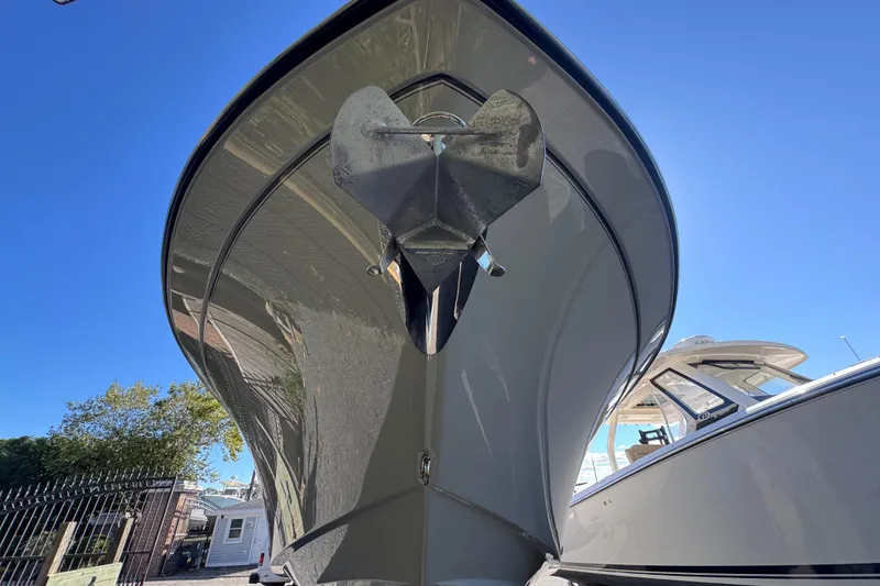 Slide: The Image of 2022 Grady-White Canyon 326 boat, close-up view of bow and anchor under clear blue sky. - 4