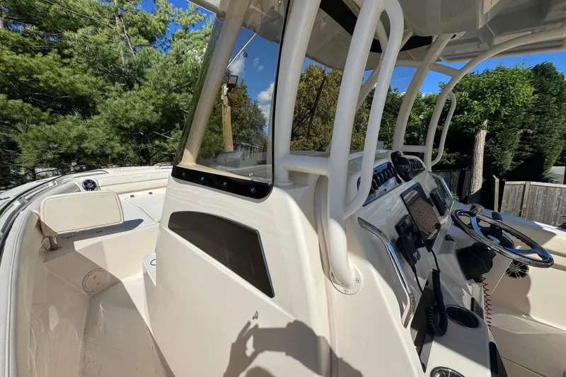 Slide: The Image of 2022 Grady-White Canyon 326 boat interior with steering console and seating area. - 45