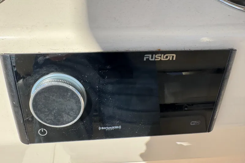 Slide: The Image of Fusion audio system on 2022 Grady-White Canyon 326 boat, featuring SiriusXM and WiFi capabilities. - 48