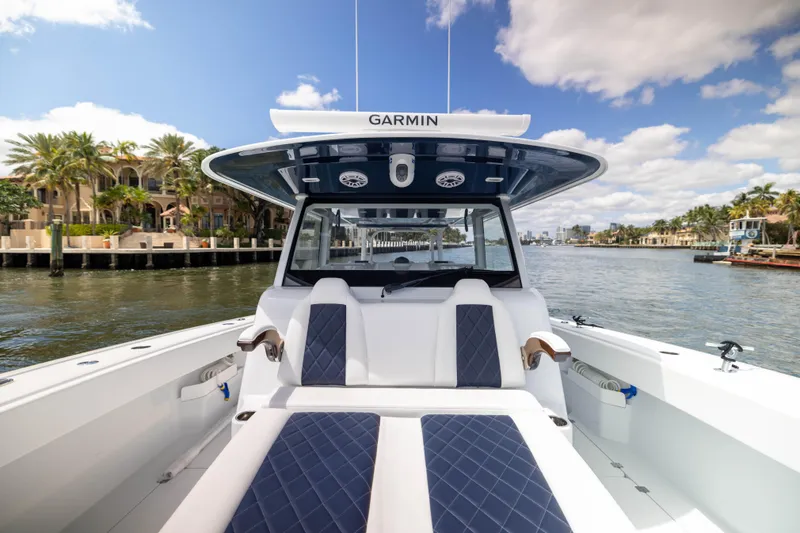 Slide: The Image of Freeman 47 LX 2026 boat interior with luxurious seating on a sunny waterfront. - 16