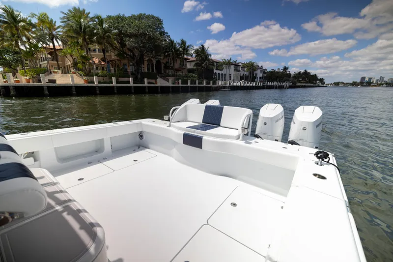 Slide: The Image of 2026 Freeman 47 LX boat on a scenic waterfront with palm trees and luxury homes. - 7