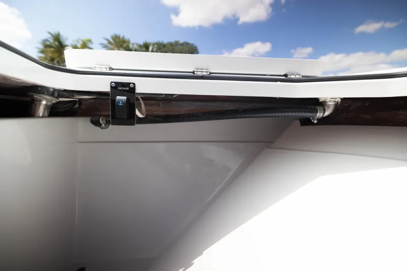 Slide: The Image of Anchor control switch on Freeman 47 LX boat, 2026 model, under clear blue sky. - 10