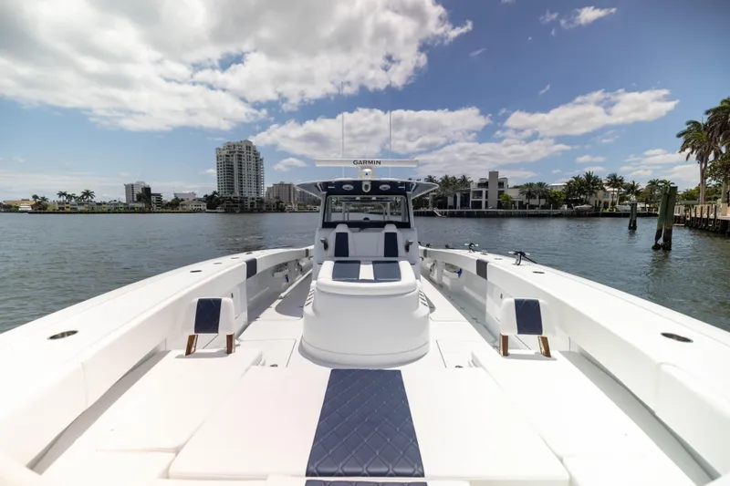 Slide: The Image of 2026 Freeman 47 LX boat on water with cityscape and palm trees in background. - 14
