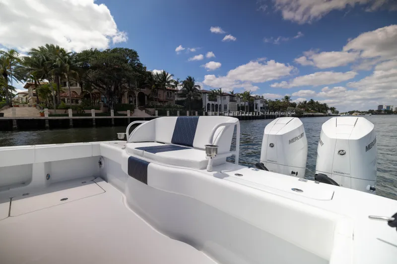 Slide: The Image of 2026 Freeman 47 LX boat with Mercury engines, docked near luxury waterfront homes. - 19