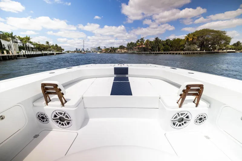 Slide: The Image of 2026 Freeman 47 LX boat interior with waterfront view, clear skies, and luxurious seating. - 2