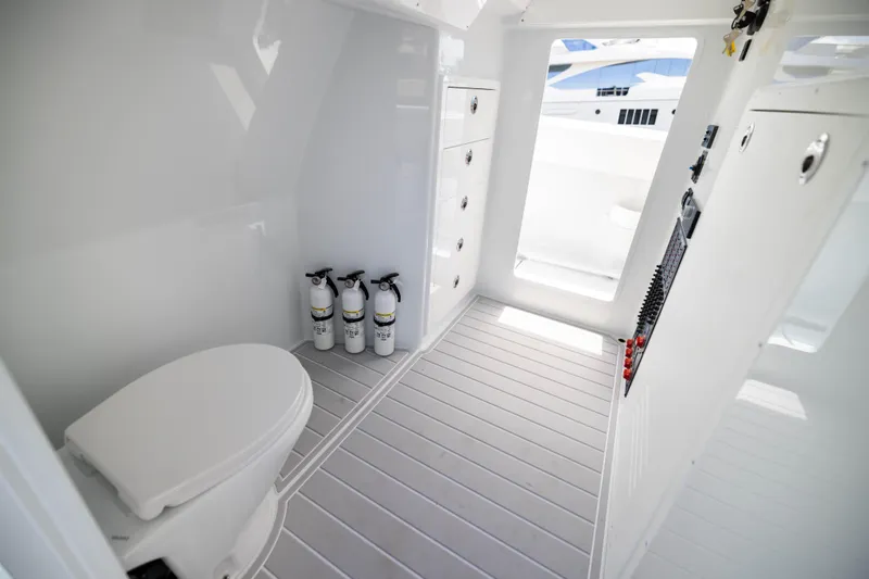 Slide: The Image of Interior of 2026 Freeman 47 LX boat with toilet and fire extinguishers. - 23
