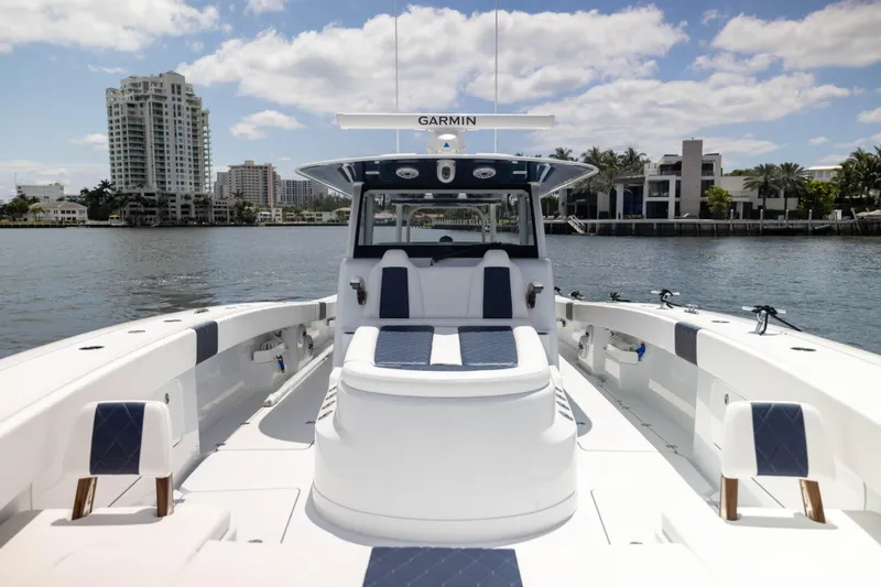 Slide: The Image of 2026 Freeman 47 LX boat on water, city skyline in background, clear sky. - 3