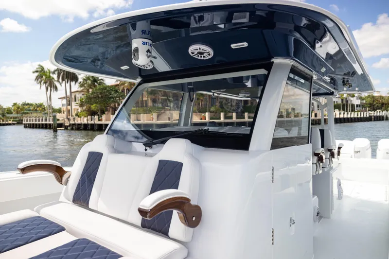 Slide: The Image of 2026 Freeman 47 LX boat with sleek design, luxurious seating, and waterfront view. - 6