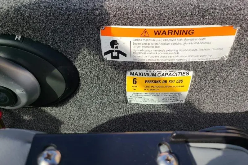 Slide: The Image of 2016 Lowe Fishing Machine 165SC Pro warning and capacity labels, 6-person limit, 854 lbs maximum. - 11