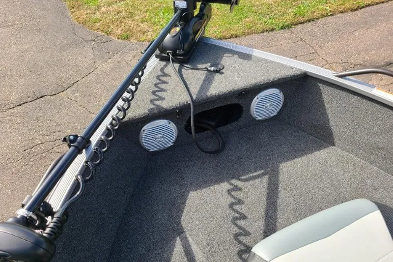 Slide: The Image of 2016 Lowe Fishing Machine 165SC Pro boat interior with trolling motor and speakers. - 12