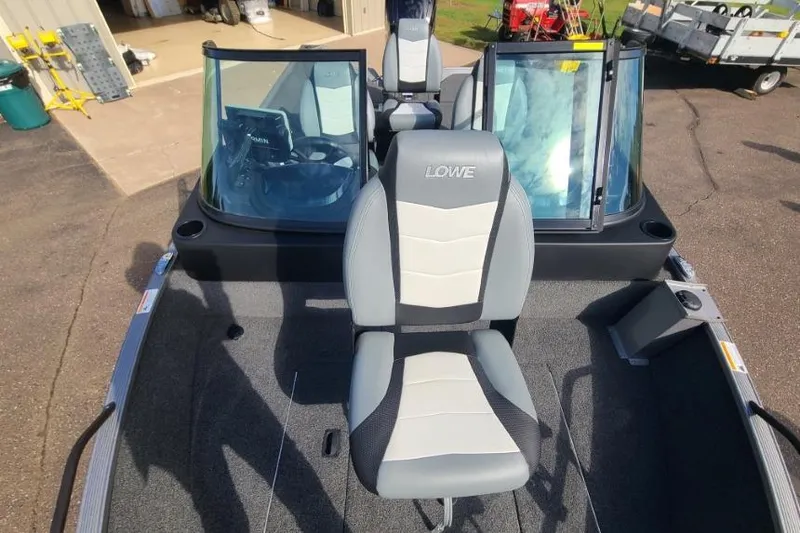 Slide: The Image of 2016 Lowe Fishing Machine 165SC Pro boat interior with seating and windshield. - 14